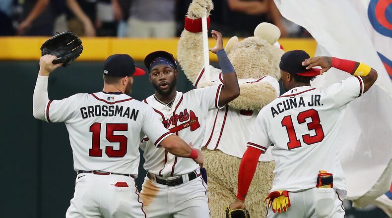 Atlanta Braves outfielders Robbie Grossman (from left), Michael Harris, and Ronald Acuna celebrate a 3-2 victory over the New York Mets to take the series in a MLB baseball game on Thursday, Aug. 18, 2022, in Atlanta. “Curtis Compton / Curtis Compton@ajc.com