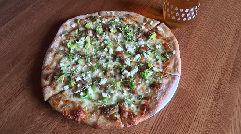 At Torched Hop Brewing Co. in Midtown, the carnitas pizza has adobo roast pork, avocado, salsa verde, sweet onion and feta, along with a heavy dash of Mexican spices. Photo: Torched Hop Brewing Co.