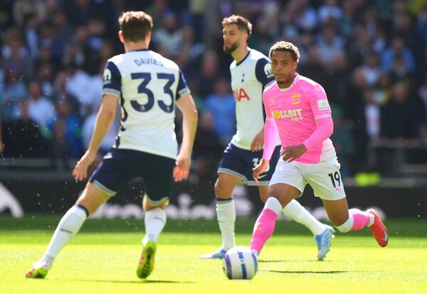 Southampton's Cameron Archer, right and Tottenham Hotspur's Ben Davies vie for the ball during the English Premier League soccer match between Tottenham Hotspur and Southampton at Tottenham Hotspur Stadium, in London, Sunday April 6, 2025. (Bradley Collyer/PA via AP)
