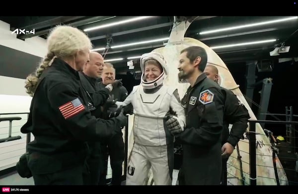 In this image made from video provided by SpaceX, one of the four astronauts, Axiom's Peggy Whitson, who served as commander, comes out of a SpaceX capsule loaded at the recovery ship after parachuting into the Pacific Ocean off the coast of Southern California on Tuesday, July 15, 2025. (SpaceX via AP)