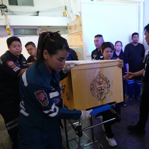 A coffin containing the body of a victim of Friday's shooting at the Debsirin Nonthaburi School, is brought in a stretcher at a police hospital in Bangkok,Thailand, Saturday, Aug. 8, 2026. (AP Photo/Sakchai Lalit)