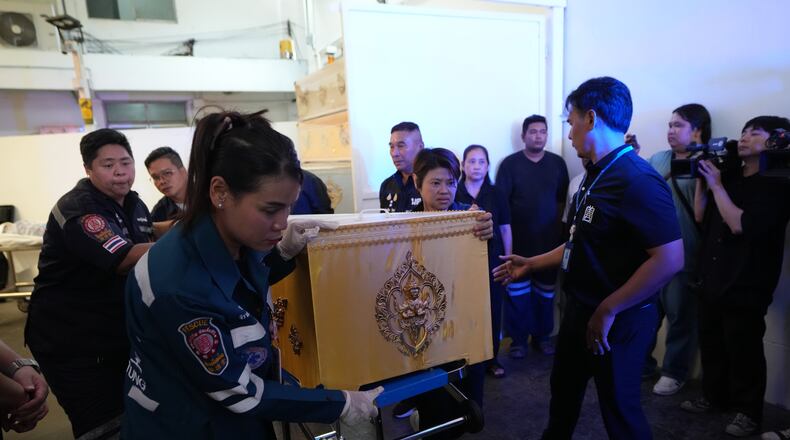 A coffin containing the body of a victim of Friday's shooting at the Debsirin Nonthaburi School, is brought in a stretcher at a police hospital in Bangkok,Thailand, Saturday, Aug. 8, 2026. (AP Photo/Sakchai Lalit)