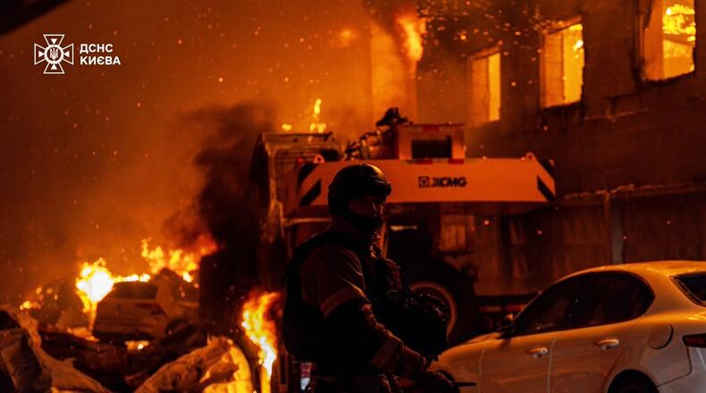 In this photo provided by the Ukrainian Emergency Service, emergency services personnel work to extinguish a fire following a Russian air attack in Kyiv, Ukraine, Wednesday, July 8, 2026. (Ukrainian Emergency Service via AP)