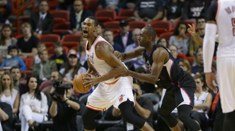 Miami Heat forward Chris Bosh, left, is defended by Los Angeles Clippers forward Luc Richard Mbah a Moute, right, during the first half of an NBA basketball game, Sunday, Feb. 7, 2016, in Miami. (AP Photo/Lynne Sladky)