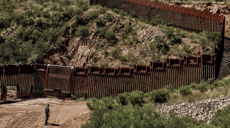 A Border Patrol agent at the fence along the border between United States and Mexico in the outskirts of Nogales, Ariz., Sept. 22, 2016. President-elect Donald J. Trump said on Jan. 6, 2017, that financing a border wall with taxpayer money would allow the work to begin more quickly. But he insisted that Mexico will ultimately reimburse the U.S. for its construction. (Tomas Munita/The New York Times/ file photo)