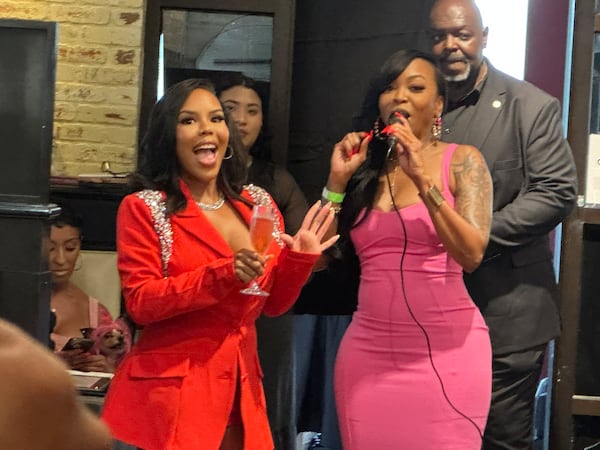 Kelli Ferrell (left), owner of Nana's Chicken-N-Waffles, opened a second restaurant and celebrated before "Real Housewives of Atlanta" cameras and media Friday. V-103 host Jazzy McBee attended the festivities. (Rodney Ho/AJC)