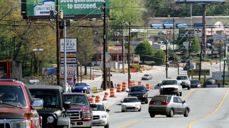Two billboards along Alpharetta Street just south of Holcomb Bridge Road in Roswell. Phil Skinner, pskinner@ajc.com