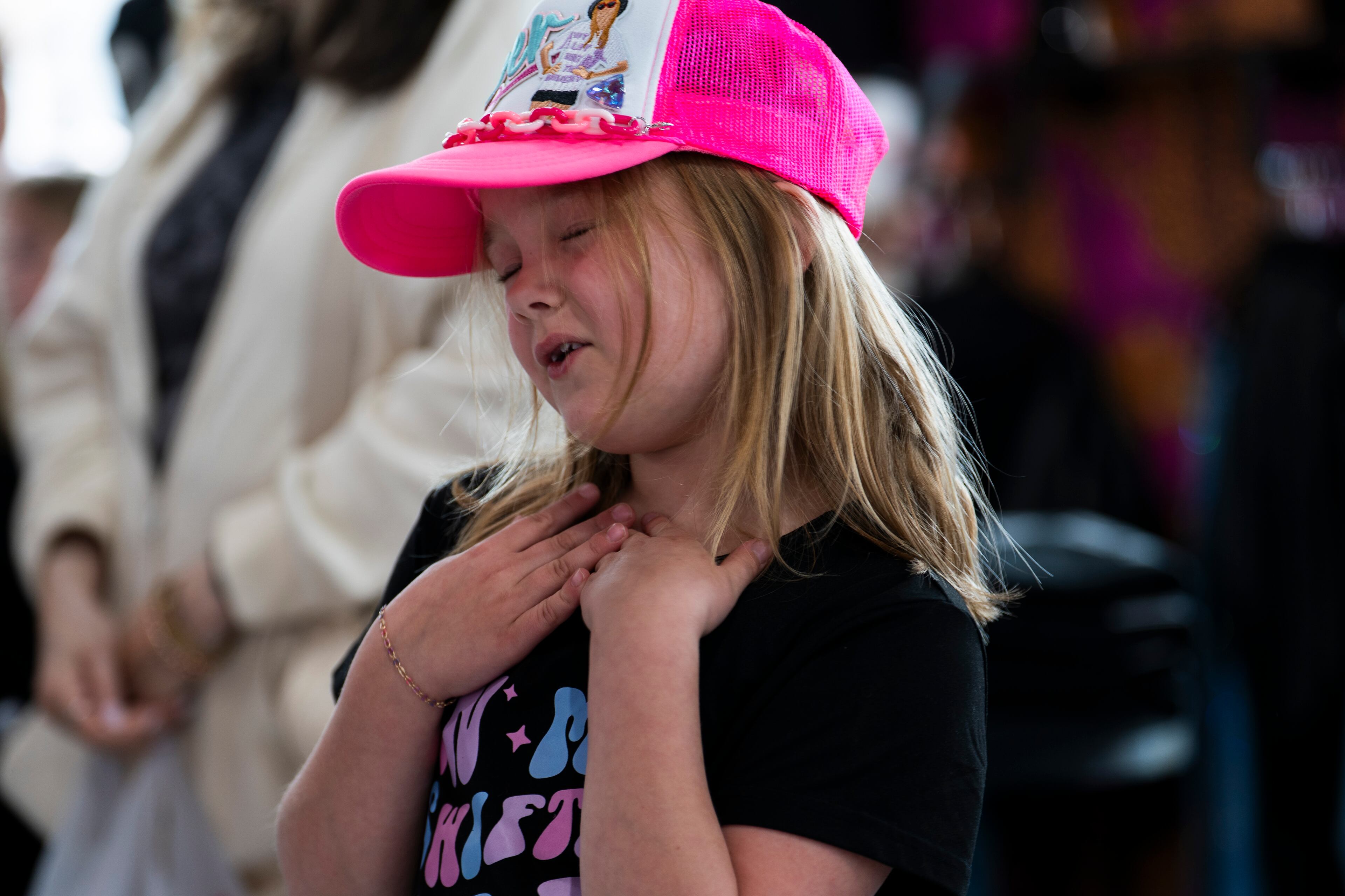 Girls dance and sing along with Michelle Paget's performance as a Taylor Swift impersonator at Roxy Moxy Boutique in Cumming, Georgia on Saturday, March 29, 2025. (Olivia Bowdoin for the AJC).