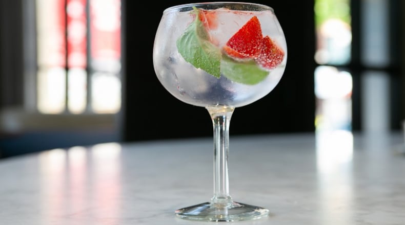 Proxi head bartender Josh Relkin offers four gin tonic variations on his cocktail menu, including strawberry-strewn version featuring Citadelle, a French gin, and pink peppercorns. (Kristan Lieb/Chicago Tribune/TNS)