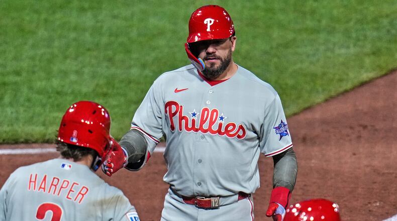 Philadelphia Phillies' Kyle Schwarber, top, is greeted by Bryce Harper (3) as he crosses home plate after hitting a two-run home run off Pittsburgh Pirates pitcher Mason Montgomery during the seventh inning of a baseball game in Pittsburgh, Friday, May 15, 2026. (AP Photo/Gene J. Puskar)