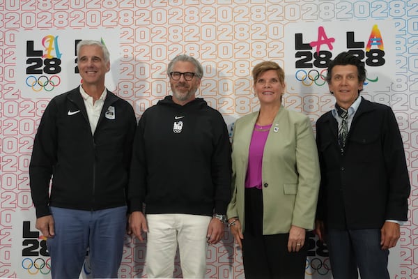 From left, Reynold Hoover, LA28 chief executive officer; Casey Wasserman, LA28 chairperson and president; Nicole Hoevertsz, IOC vice president and LA28 Coordination Commission chair; and Christophe Dubi, IOC Olympic Games executive director, pose for a picture after a news conference about the progress of the LA28 Games in Los Angeles, Thursday, June 5, 2025. (AP Photo/Damian Dovarganes)