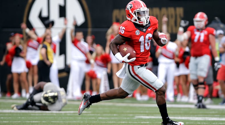 FILE - In this Sept. 12, 2015, file photo, Georgia's Isaiah McKenzie (16) returns a punt 77 yards for a touchdown against Vanderbilt in the first half of an NCAA college football game in Nashville, Tenn. If the Bulldogs beat Florida, they could clinch the East by knocking off Kentucky and Auburn the following two weeks. (AP Photo/Mark Humphrey, File)