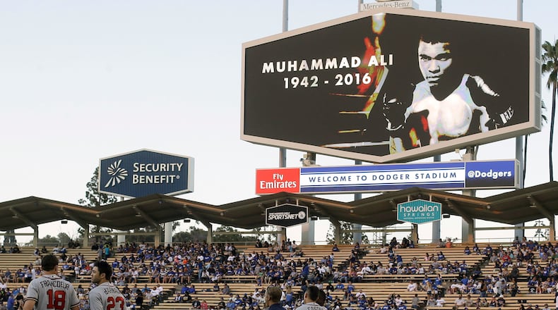 Members of the Atlanta Braves stand on the field during a moment of silence for boxer Muhammad Ali before a baseball game between the Los Angeles Dodgers and the Atlanta Braves in Los Angeles, Saturday, June 4, 2016. (AP Photo/Chris Carlson)
