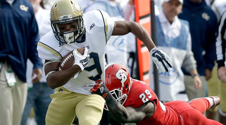 North Carolina State's Jack Tocho (29) dives as Georgia Tech's Tony Zenon (9) runs the ball during the first half of an NCAA college football game in Raleigh, N.C., Saturday, Nov. 8, 2014. (AP Photo/Gerry Broome)