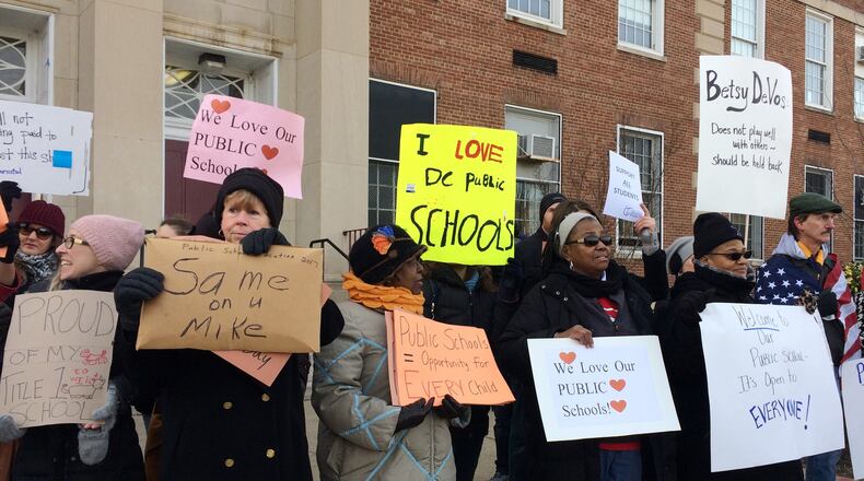 Despite her confirmation Tuesday, Betsy DeVos is still facing protests. Protesters gathered outside Jefferson Middle School in Washington today as DeVos paid her first visit as education secretary in a bid to mend fences with educators after a bruising confirmation battle. (AP Photo/Maria Danilova)