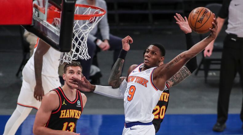 New York Knicks guard RJ Barrett (9) dunks against the Atlanta Hawks during the third quarter of an NBA basketball game Wednesday, April 21, 2021, in New York. (Wendell Cruz/Pool Photo via AP)