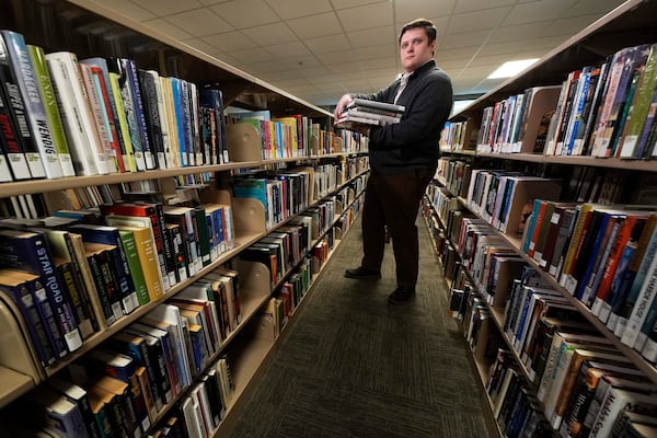Spencer Davis, one of several librarians slated to be laid off due to DOGE cuts, works at the Maine State Library, Wednesday, May 7, 2025, in Augusta, Maine. (AP Photo/Robert F. Bukaty)