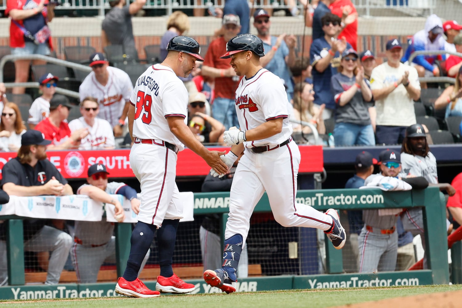Atlanta Braves catcher Drake Baldwin (30) shakes hands with Atlanta Braves third base coach Matt Tuiasosopo (89) after hitting a two-RBI home run during the third inning against the Minnesota Twins at Truist Park on Sunday, April 20, 2025, in Atlanta. 
(Miguel Martinez/ AJC)