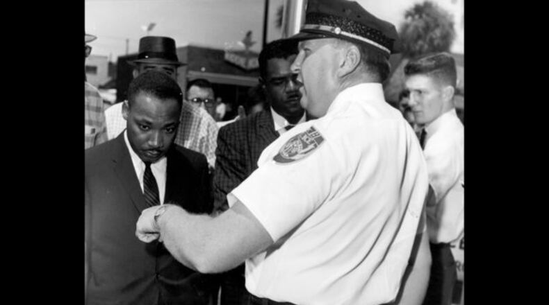 In this July 27, 1962, file photo, the Rev. Dr. Martin Luther King Jr. is arrested by Albany's Chief of Police Laurie Pritchett after praying at City Hall in Albany. King participated in a month-long campaign of local anti-segregation led by the Southern Christian Leadership Conference. AP FILE Photo