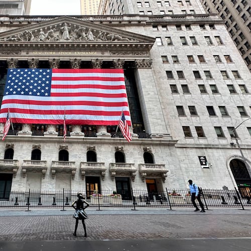 FILE - People pass the New York Stock Exchange on May 28, 2024, in New York. (AP Photo/Peter Morgan, File)