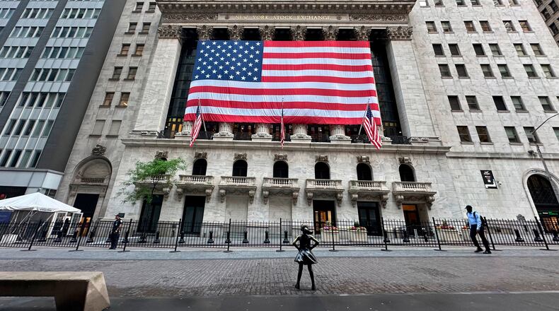FILE - People pass the New York Stock Exchange on May 28, 2024, in New York. (AP Photo/Peter Morgan, File)
