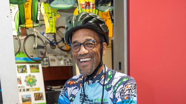 Atiba Mbiwan, the director of the BRAG Dream Team, poses on his bicycle inside the organization's headquarters at Pittsburgh Yards in Atlanta. (Phil Skinner for the AJC)