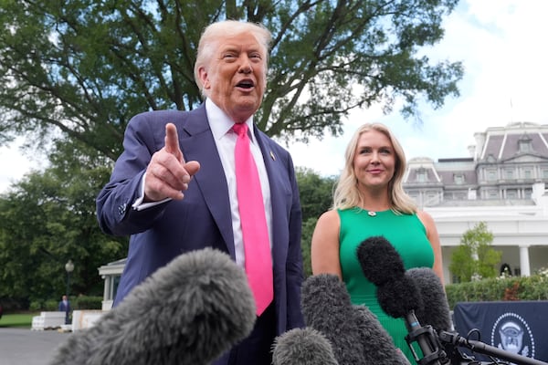 President Donald Trump speaks to the media as he leaves the White House, Tuesday, July 15, 2025, in Washington, as White House press secretary Karoline Leavitt, looks on. (AP Photo/Manuel Balce Ceneta)