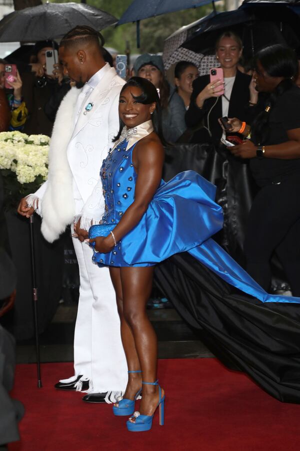 Jonathan Owens, left, and Simone Biles depart The Carlyle Hotel prior to attending The Metropolitan Museum of Art's Costume Institute benefit gala celebrating the opening of "Superfine: Tailoring Black Style" on Monday, May 5, 2025, in New York. (Photo by Andy Kropa/Invision/AP)