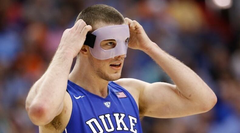 Duke center Marshall Plumlee (40) adjust his mask during the second half of an NCAA college basketball game in the Atlantic Coast Conference tournament, in Washington , Thursday, March 10, 2016. Plumlee bork his nose in Wednesday's game. Notre Dame defeated Duke 84-79. (AP Photo/Steve Helber)