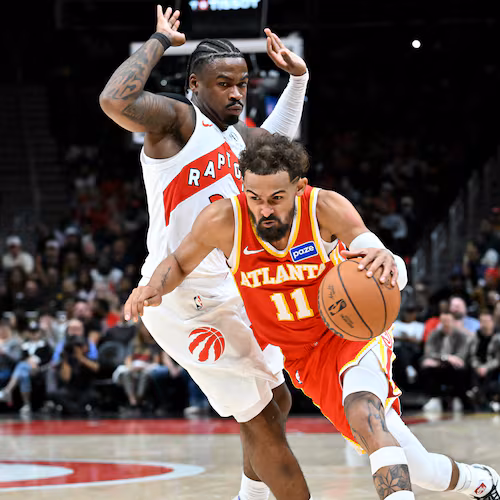 Atlanta Hawks guard Trae Young drives past Toronto Raptors guard Jamal Shead during the second half in the home opener at State Farm Arena, Thursday, Oct. 22, 2025, in Atlanta. Young will miss his fourth straight game on Saturday with a right quad contusion and he has played in just 10 games this season. (Hyosub Shin/AJC)