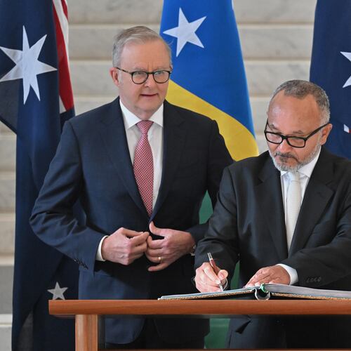 Solomon Islands' Prime Minister Matthew Wale, right, signs a visitors book as Australian Prime Minister Anthony Albanese watches at Parliament House in Canberra, Wednesday, June 3, 2026. (Mick Tsikas/AAP Image via AP)