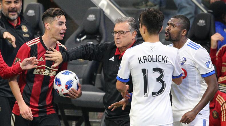 April 28, 2018 Atlanta: Atlanta United head coach Gerardo Martino breaks up a heated confrontation between Miguel Almiron (left) and Montreal Impact player Chris Duval (right) during the second half in a MLS soccer match on Saturday, April 28, 2018, in Atlanta.  Curtis Compton/ccompton@ajc.com