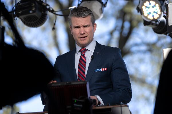 Defense Secretary Pete Hegseth prepares to give a television interview outside the White House, Friday, March 21, 2025, in Washington. (AP Photo/Mark Schiefelbein)