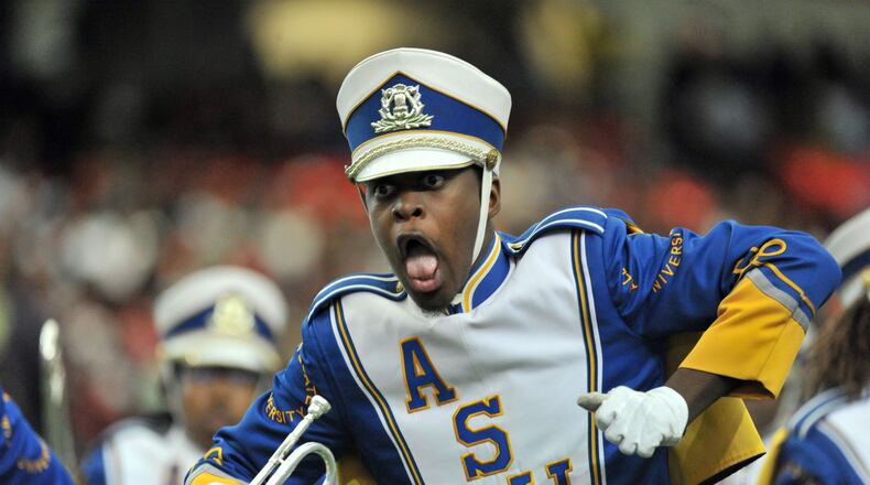 A member of Albany State University “Marching Rams Show Band” performs during a Honda Battle of the Bands at the Georgia Dome. The band will represent Georgia in the 2016 Rose Bowl Parade in January. HYOSUB SHIN/hshin@ajc.com