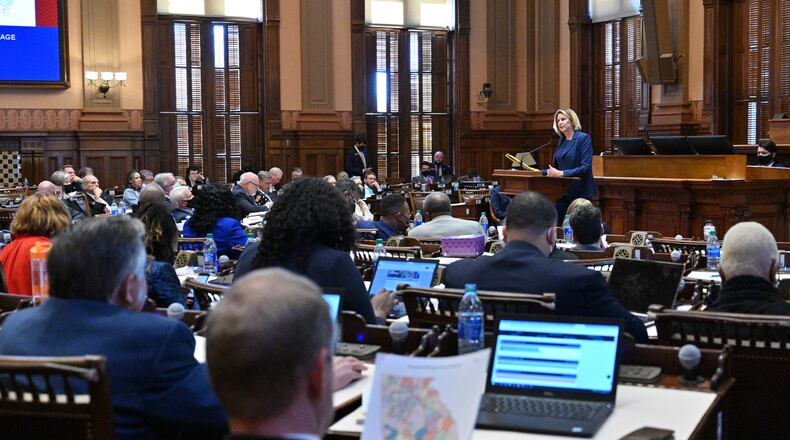 House Speaker Pro Temp Rep. Jan Jones speaks in favor of HB 1 EX as Rep. Bill Werkheiser (R-Glennville), foreground, looks at proposed maps in the House Chambers during Day 6 of the special session at the Georgia State Capitol in Atlanta on Wednesday, November 10, 2021. (Hyosub Shin / Hyosub.Shin@ajc.com)