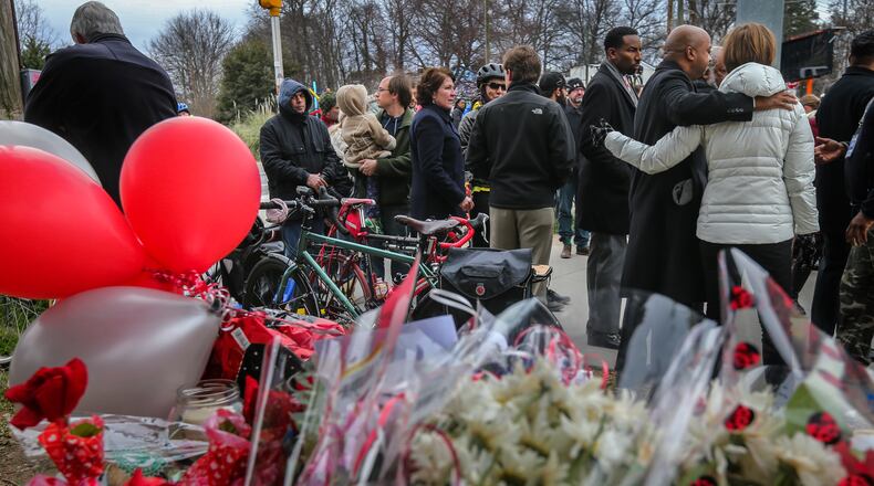 In 2016, a group gathered in front of the memorial for Alexia Hyneman after the Grady High School freshman was hit and killed while riding her bicycle at 10th Street and Monroe Drive. On Tuesday, Feb. 12, the Grady Pedestrian Safety Coalition will hold a rally on the third anniversary of the student's death. JOHN SPINK /JSPINK@AJC.COM
