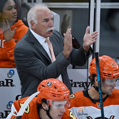 Anaheim Ducks head coach Joel Quenneville, center top, yells to his players during the second period of an NHL hockey game against the Chicago Blackhawks, Sunday, Oct. 19, 2025, in Chicago. (AP Photo/Paul Beaty)