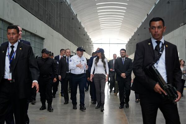 Minister of Justice and Public Security Héctor Villatoro accompanies Homeland Security Secretary Kristi Noem during a tour of cellblock 7 of the Terrorist Confinement Center in Tecoluca, El Salvador, Wednesday, March 26, 2025. (AP Photo/Alex Brandon)