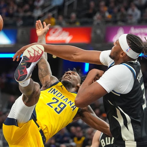 Milwaukee Bucks center/forward Myles Turner (3) fouls Indiana Pacers guard Quenton Jackson (29) as he shoots during the second half of an NBA basketball game in Indianapolis, Monday, Nov. 3, 2025. (AP Photo/Michael Conroy)