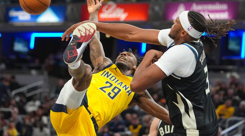 Milwaukee Bucks center/forward Myles Turner (3) fouls Indiana Pacers guard Quenton Jackson (29) as he shoots during the second half of an NBA basketball game in Indianapolis, Monday, Nov. 3, 2025. (AP Photo/Michael Conroy)