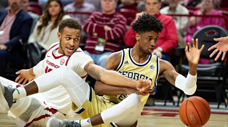 Arkansas’ Daniel Gafford goes for a loose ball against Georgia Tech’s Khalid Moore Wednesday, Dec. 19, 2018, at Bud Walton Arena in Fayetteville, Ark.