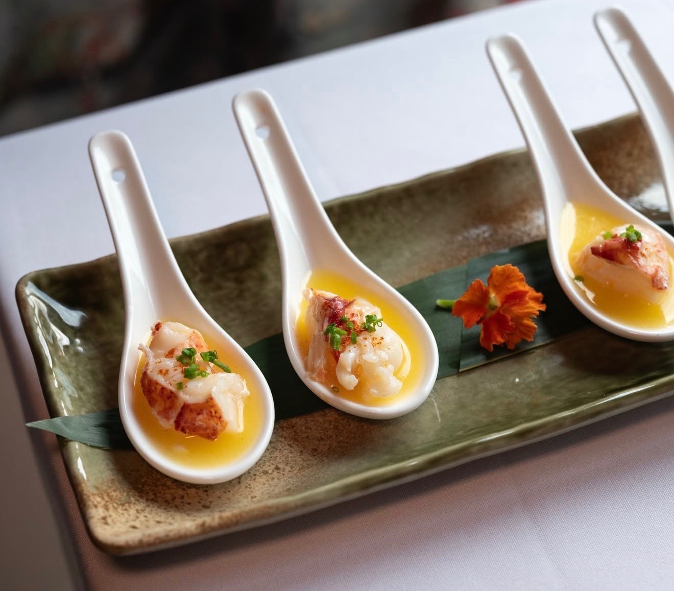 Lobster spoons, four for $29, place tender lobster in a pool of perfectly executed beurre blanc sauce at Lo Kee in West Midtown. (Courtesy of Lo Kee)