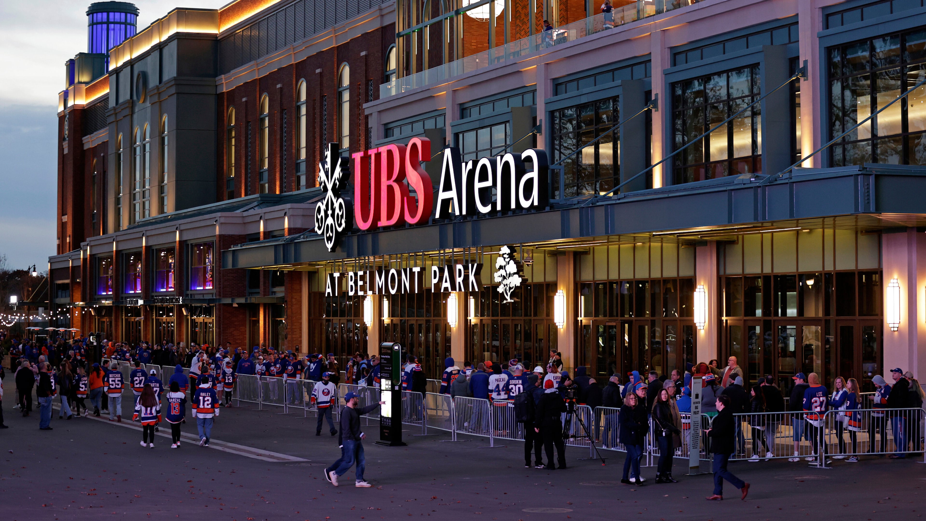 FILE - Fans wait to enter the new UBS Arena for the first New York Islanders NHL hockey game against the Calgary Flames, Nov. 20, 2021, in Elmont, N.Y. (AP Photo/Adam Hunger, File)wld