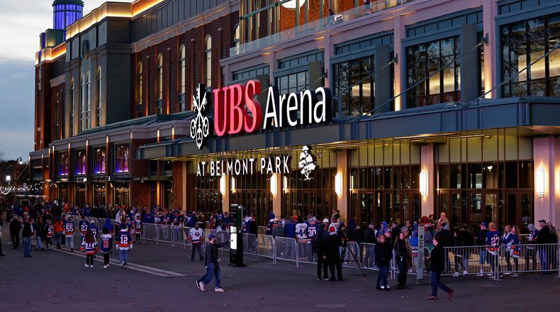 FILE - Fans wait to enter the new UBS Arena for the first New York Islanders NHL hockey game against the Calgary Flames, Nov. 20, 2021, in Elmont, N.Y. (AP Photo/Adam Hunger, File)wld