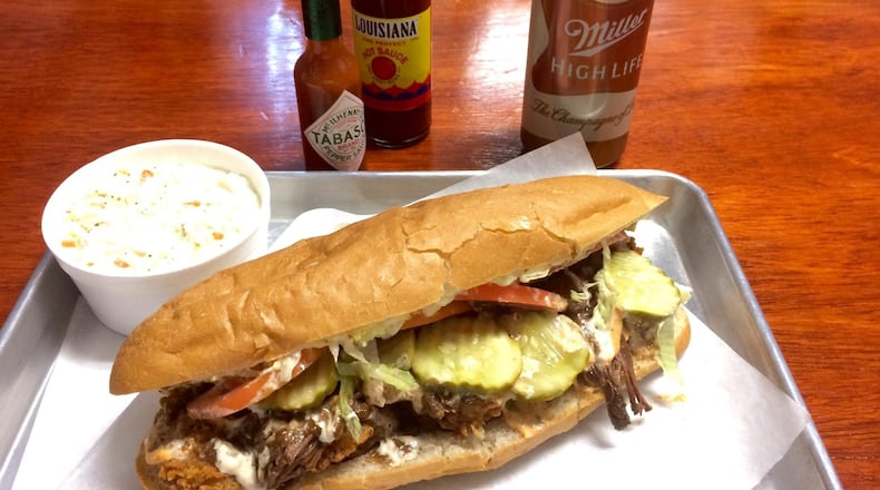The Surf & Turf po’boy at the Po’Boy Shop in Decatur is made with fried shrimp topped with roast-beef debris. CONTRIBUTED BY WENDELL BROCK