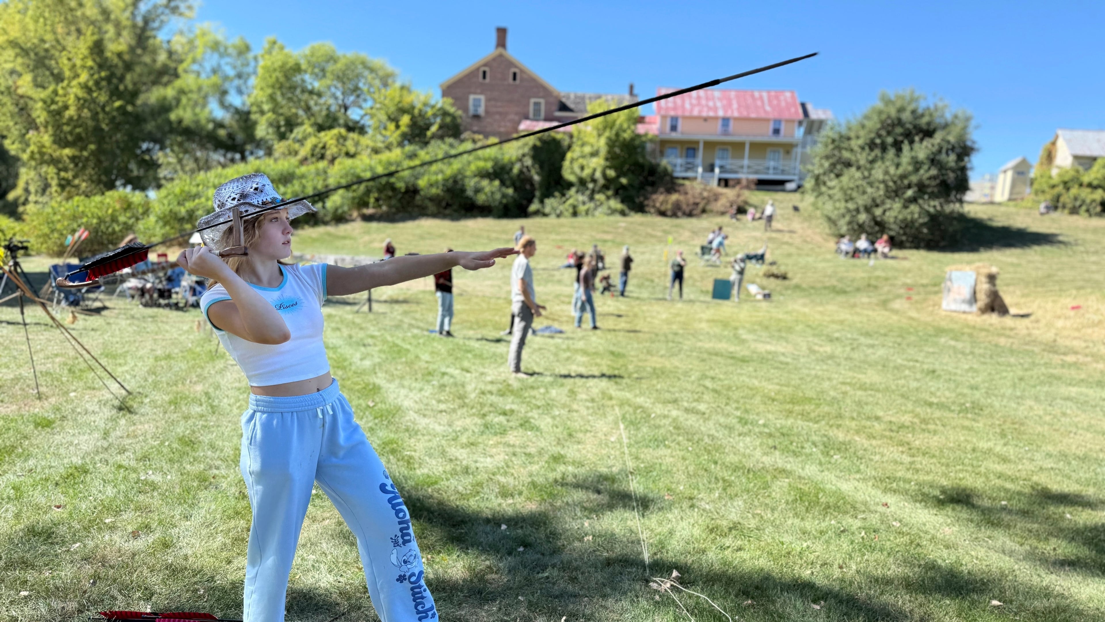 12-year-old Ava Nolf of Clinton, Connecticut practices throwing an atlatl during the Northeastern Atlatl Championship in Addison, Vt. on Saturday, Sept. 20, 2025. (AP Photo/Amanda Swinhart)