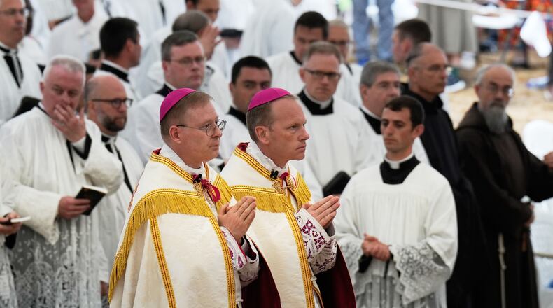 Father Pascal Schreiber, left, and father Michael Goldade arrive for their consecration ceremony as bishops in a tent set up outside the Society of St. Pius X seminary, in Econe, Switzerland, Wednesday, July 1, 2026. (AP Photo/Baz Ratner)