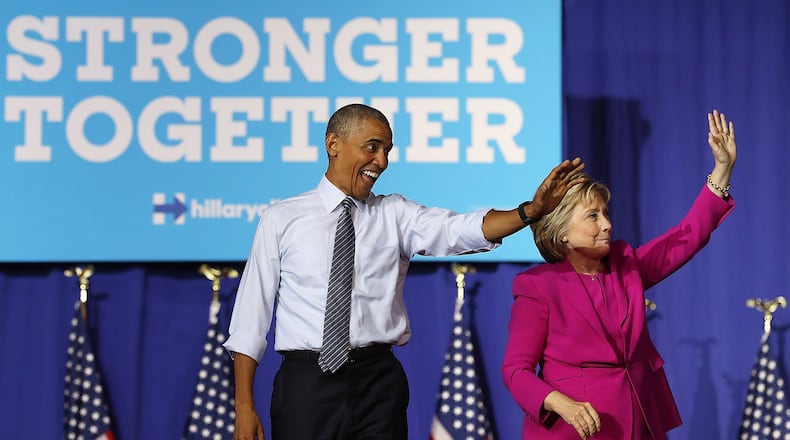 CHARLOTTE, NC - JULY 05: Democratic presidential candidate former Secretary of State Hillary Clinton (R) and U.S. president Barack Obama greet supporters during a campaign rally on July 5, 2016 in Charlotte, North Carolina. Hillary Clinton is campaigning with president Obama in North Carolina. (Photo by Justin Sullivan/Getty Images)