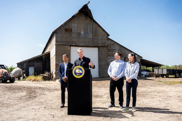 California Gov. Gavin Newsom discusses President Donald Trump's tariffs, as California Attorney General Rob Bonta, left, Sierra Pacific Warehouse Group CEO Chris Murphy and almond farmer Christine Gemperle, listen, during a press conference on Wednesday, April 16, 2025, at an almond farm in Ceres, Calif. (AP Photo/Noah Berger)