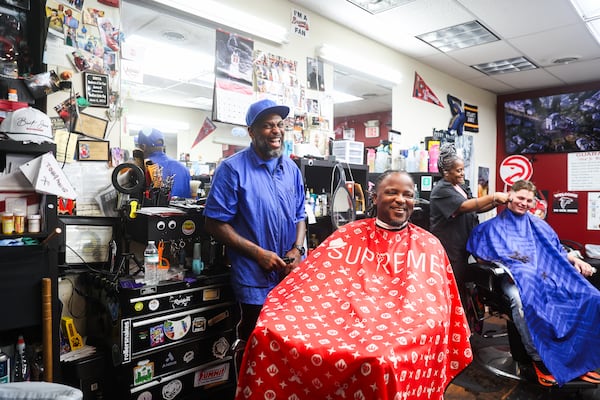 Owner of Headliners Barbershop Greg Patterson laughs with his client at his shop in Jackson, on Saturday, June 6, 2026. (Abbey Cutrer/AJC)